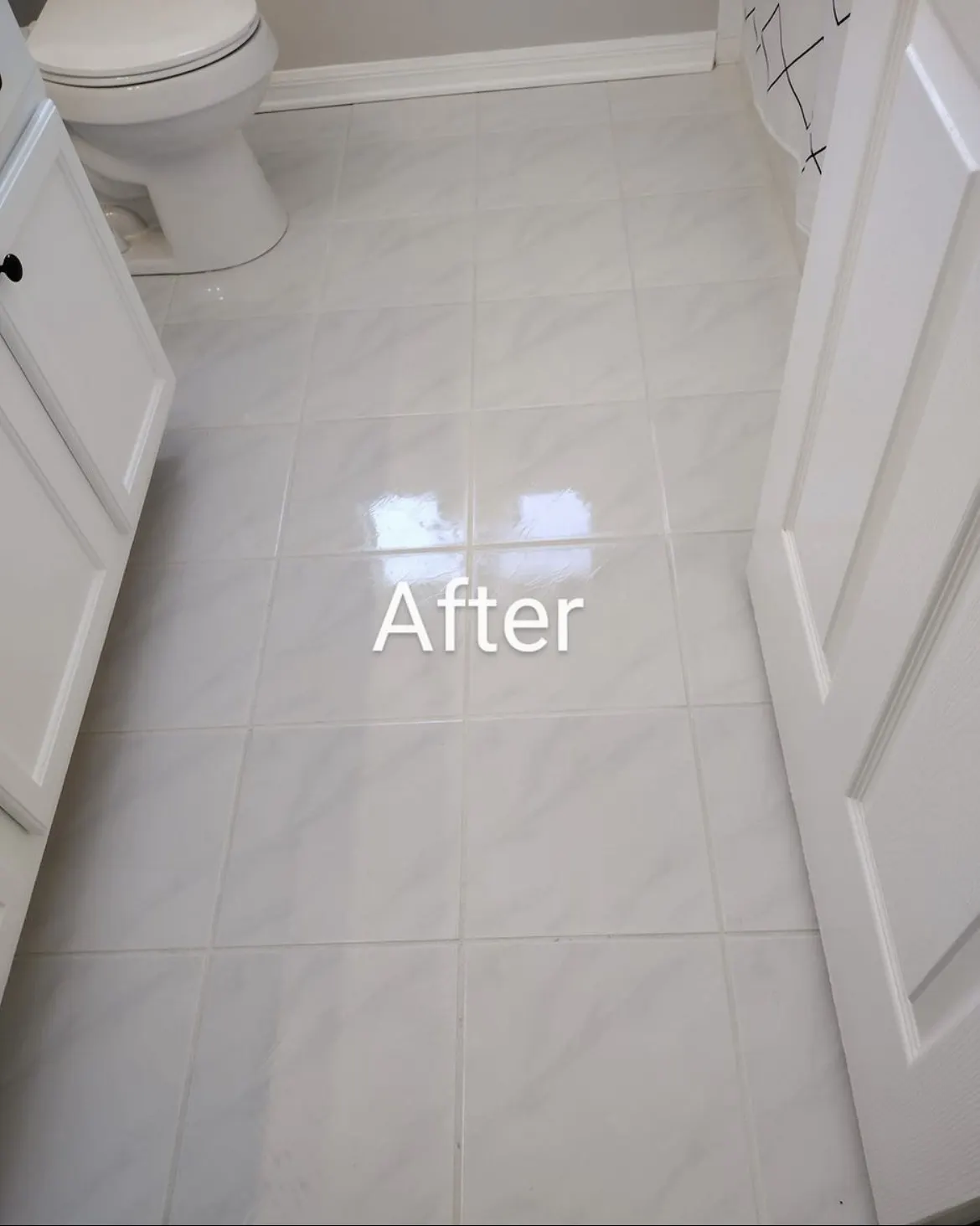 The same bathroom tile floor after cleaning, with bright grout lines