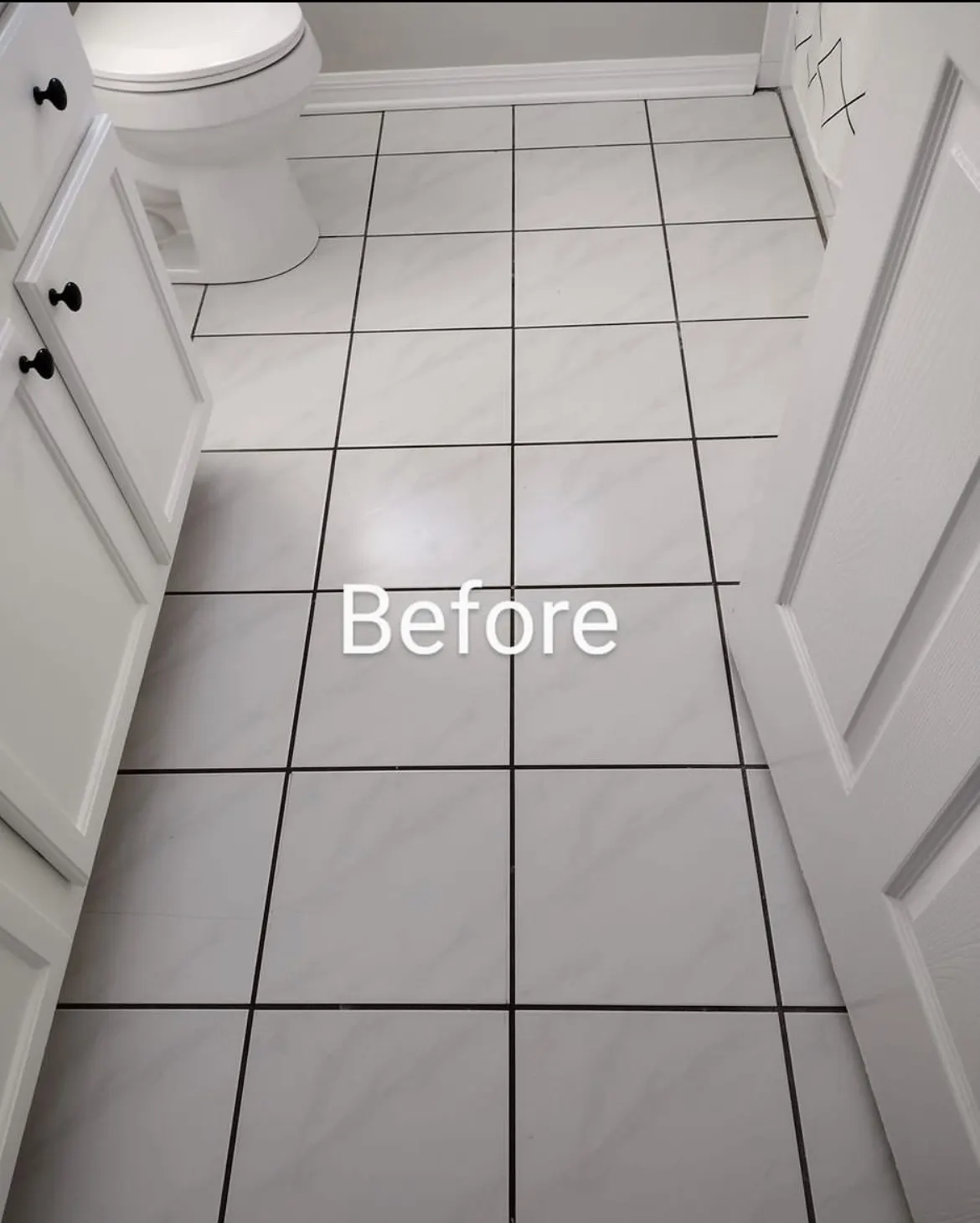 Bathroom tile floor before restoration with darkened grout lines