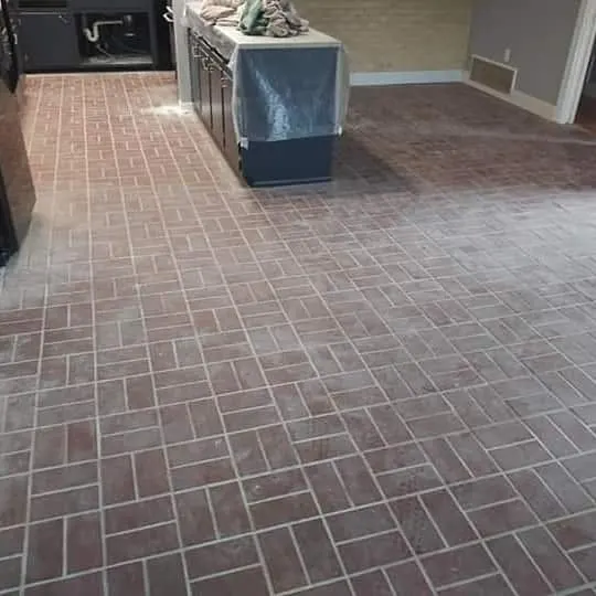 Interior brick floor half restored, showing the before and after side by side