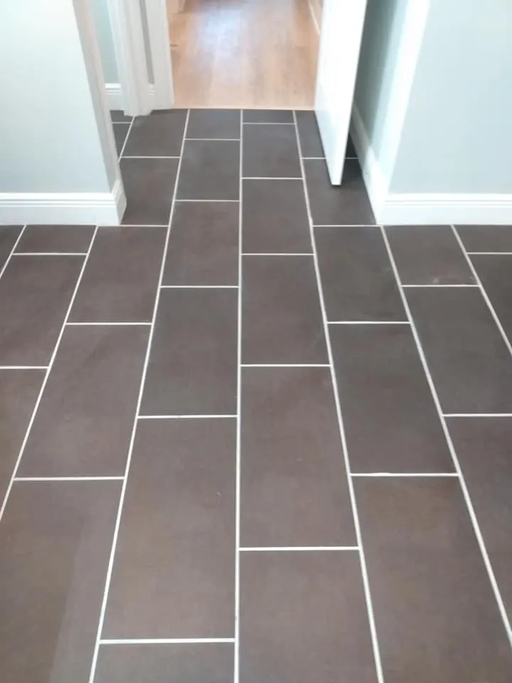 Dark tile floor after cleaning with crisp, even grout lines