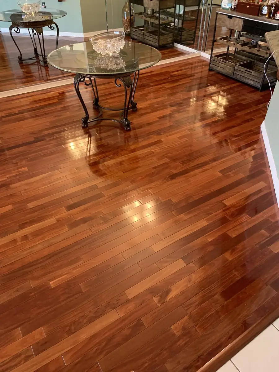 Restored hardwood floor with a deep gloss around a patio table