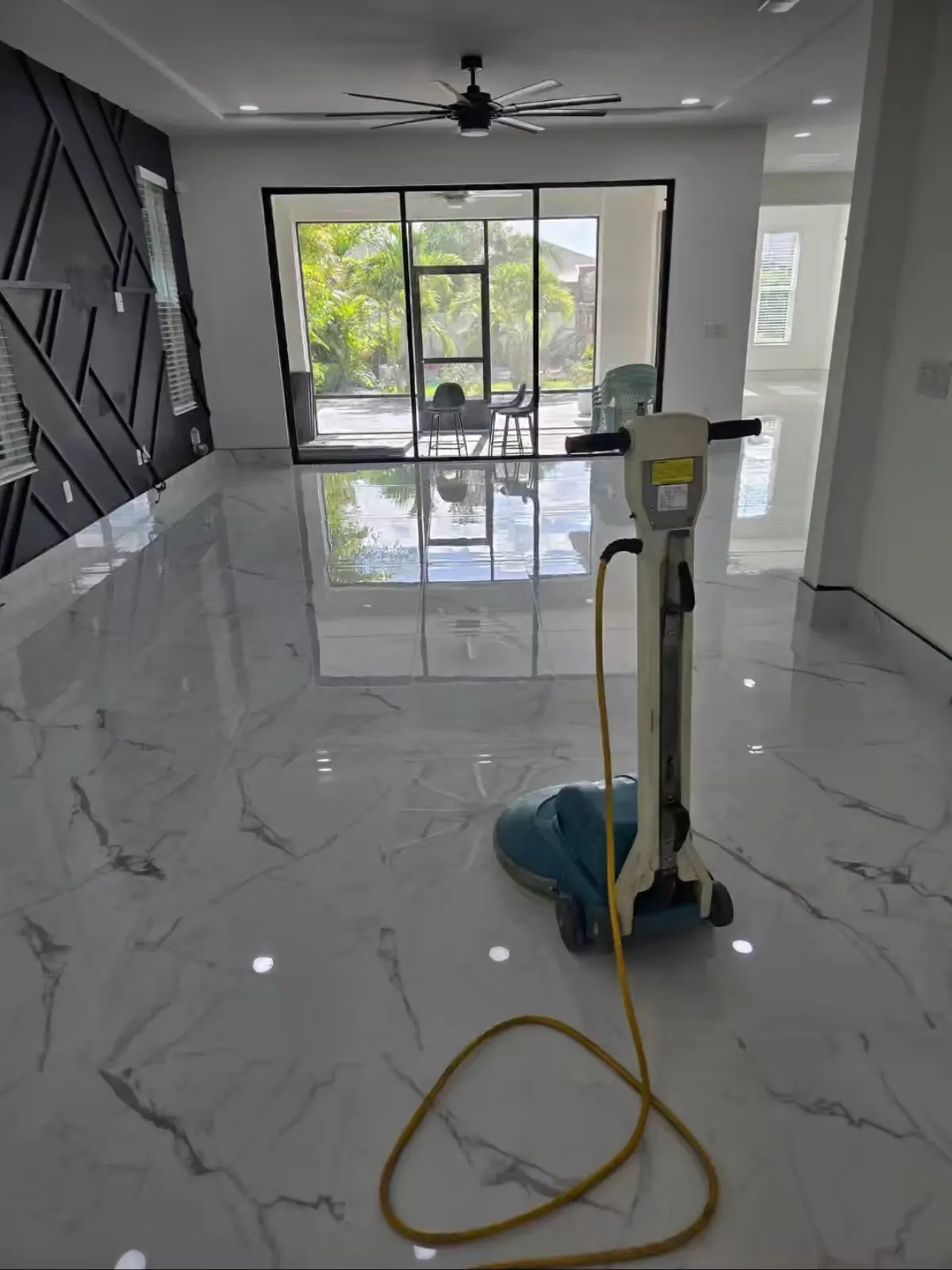 Stone floor being honed and polished with a rotary machine