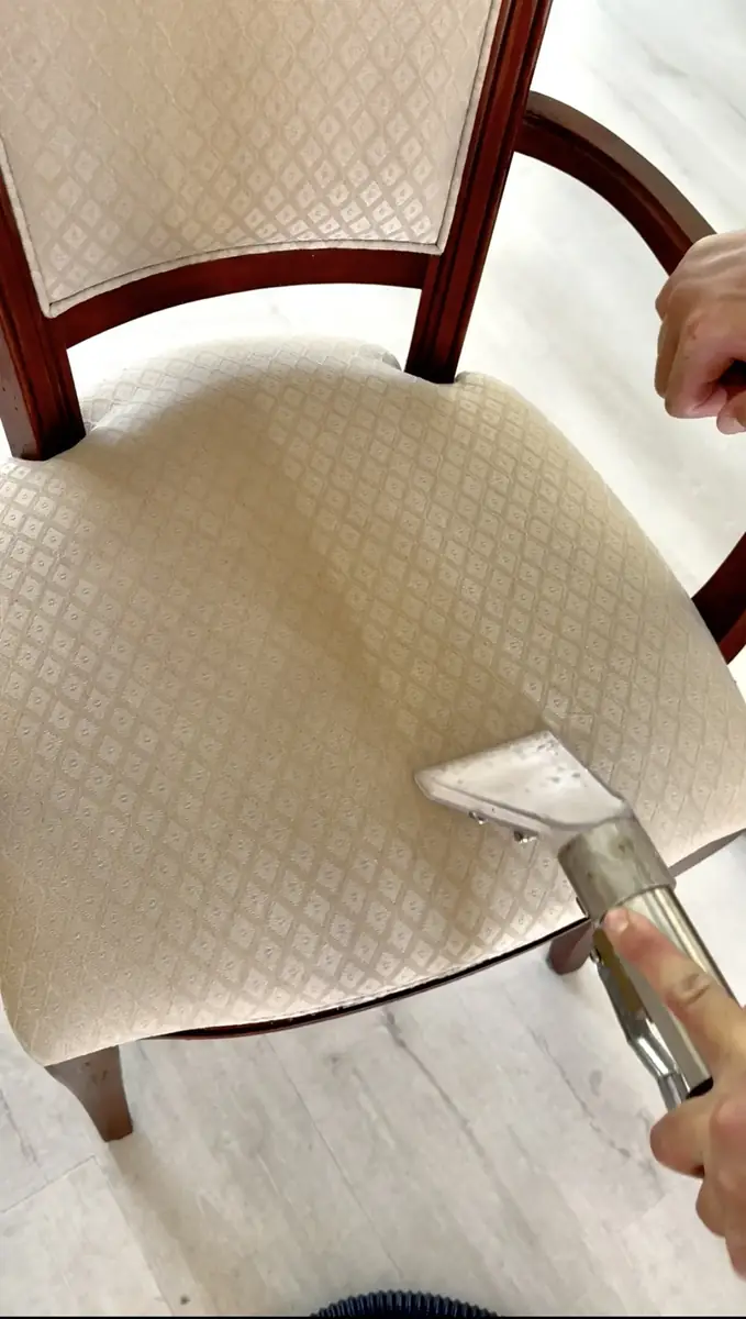 Upholstery cleaning with an extraction wand on a dining chair